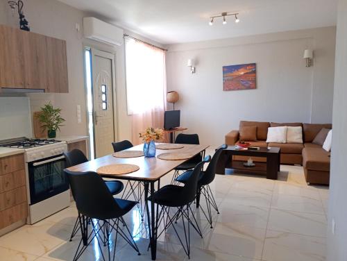 a kitchen and living room with a table and chairs at Village House in Ágios Matthaíos