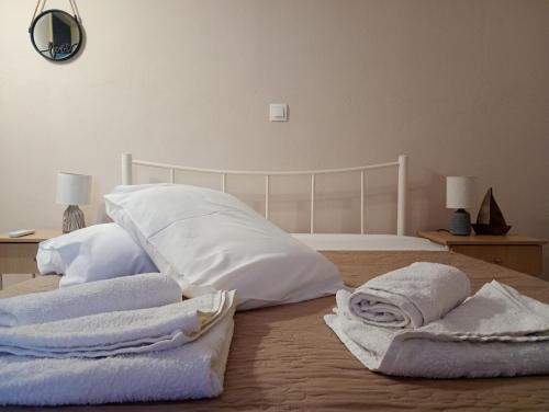 a bedroom with white towels on a bed at Village House in Ágios Matthaíos