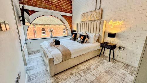 a bedroom with a bed in a room with a window at Canal Side Luxury Apartment in Leeds City Centre Sleeps 3 in Leeds
