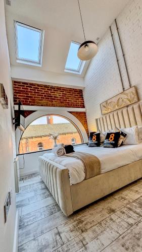 a bedroom with a large bed with a large window at Canal Side Luxury Apartment in Leeds City Centre Sleeps 3 in Leeds