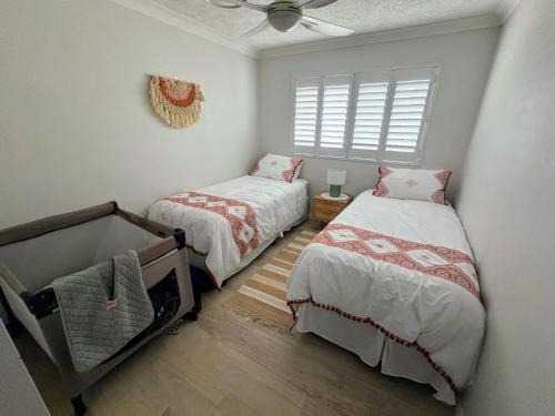 a bedroom with two beds and a window at Oceanside Cove in Gold Coast