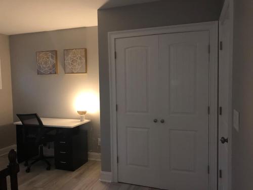 a room with a door and a desk with a lamp at Cheerful 3-bedroom home in Newnan