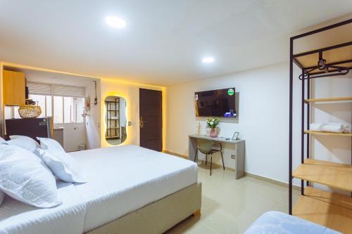 a bedroom with a bed and a desk in it at Comuna Loft in Medellín