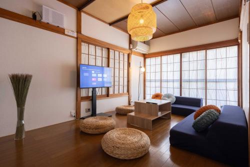 a living room with a couch and a flat screen tv at Lido Urayasu in Tokyo
