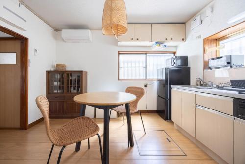 a kitchen with a table and chairs in a kitchen at Lido Urayasu in Tokyo