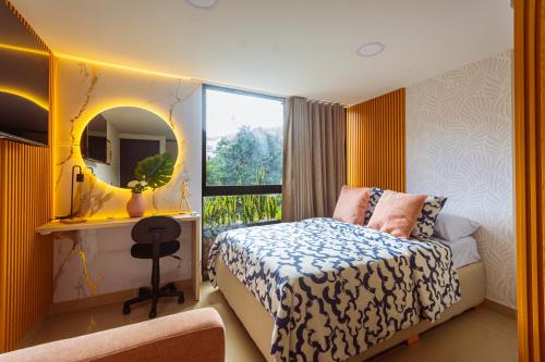 a bedroom with a bed with a mirror and a window at Comuna Loft in Medellín