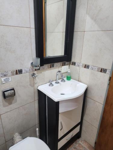 a bathroom with a sink and a toilet at Cabañas Dulce Atardecer in Villa Carlos Paz
