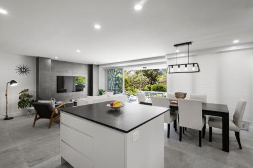 a kitchen and dining room with a table and chairs at Sunshine Vista in Sunshine Beach