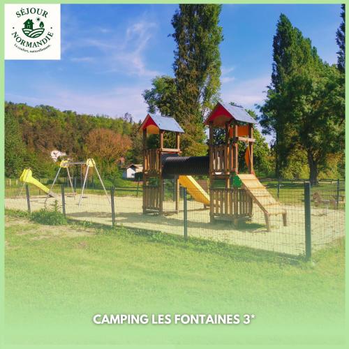 a playground with two play equipment in a park at Mobile home 6P XL Climatisation TV WIFI parcelle XXL au calme in Ivry-la-Bataille