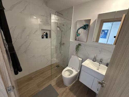 a bathroom with a toilet and a shower and a sink at Crystal Lagoon White Sands Beach in Punta Cana