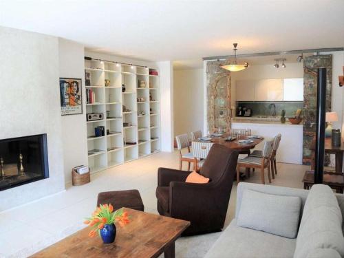 a living room with a table and a dining room at Residence Golf Parco in Ascona