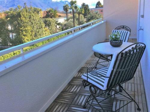 a table and chairs on a balcony with a view at Residence Golf Parco in Ascona