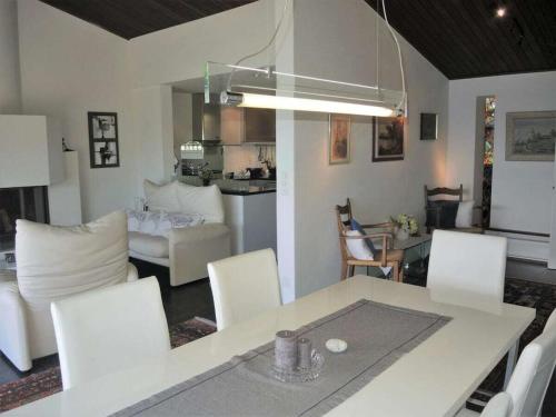 a kitchen and living room with a table and chairs at 1-bedroom holiday home in Ponte Brolla