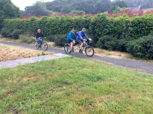 three people riding bikes down a road at Number 7 Gouarec in Gouarec