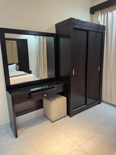 a bedroom with a large mirror and a bed at الوان للشقق المخدومة in Khamis Mushayt