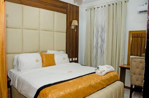Postel nebo postele na pokoji v ubytování Triple J's Inn & Apartments