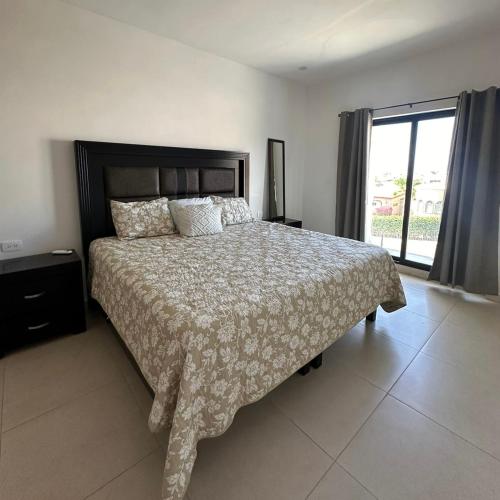 a bedroom with a large bed and a large window at Casa SOLÉA San Carlos in San Carlos