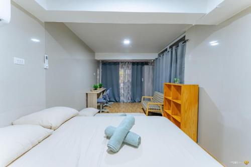a bedroom with a bed with a blue stuffed animal on it at Ideal place to stay for 8-12pax with Parking Area in Mactan Island