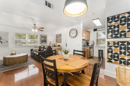 a dining room and living room with a table at Gator Suites - Near UF, Shands & VA! in Gainesville