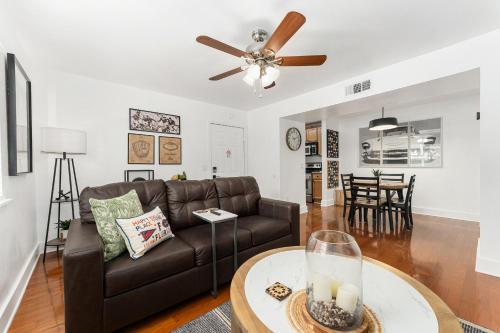 a living room with a couch and a table at Gator Suites - Near UF, Shands & VA! in Gainesville