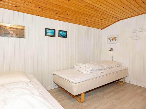 a bedroom with two beds and a wooden ceiling at 4 person holiday home in Thisted in Thisted