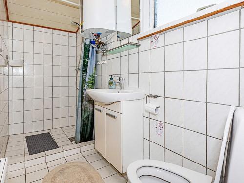 a bathroom with a toilet and a sink at 4 person holiday home in Thisted in Thisted
