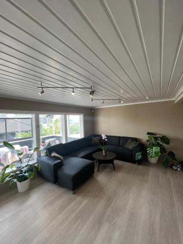 a living room with a couch and a table at Sentral enebolig på Lura med Jacuzzi! in Stavanger