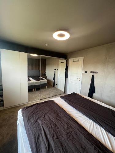 a bedroom with a large bed in a room at Sentral enebolig på Lura med Jacuzzi! in Stavanger