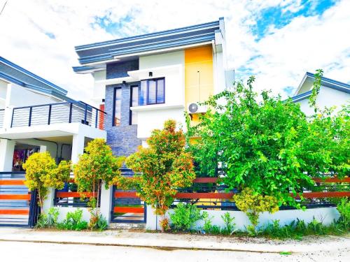 a white house with trees in front of it at Casa Bella 3BR Home in Capas Tarlac near New Clark City in Capas