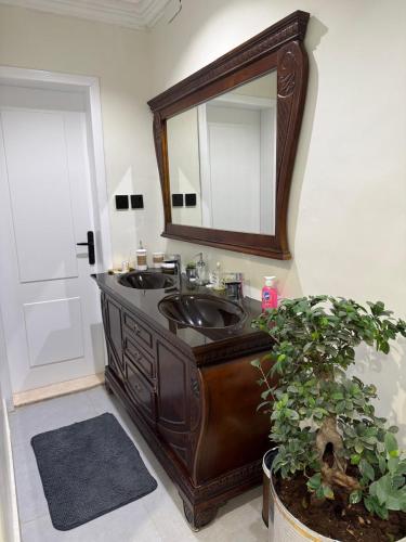 a bathroom with a wooden sink and a mirror at فيلا فيو السلطان in Abha