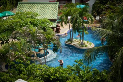 a pool at a resort with people swimming in it at Baan Karonburi Resort in Karon Beach