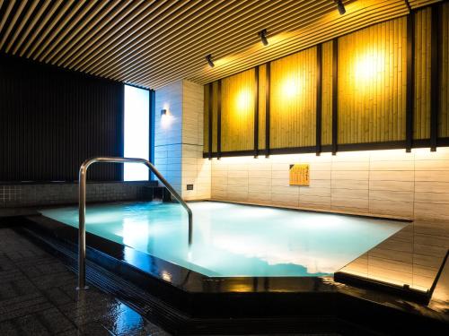 a large pool of water in a room with at APA Hotel & Resort Osaka Namba Ekimae Tower in Osaka