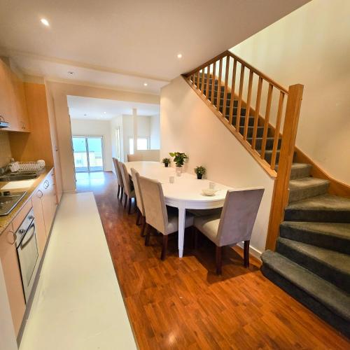 a kitchen and dining room with a table and chairs at The Regent Guesthouse in Sydney
