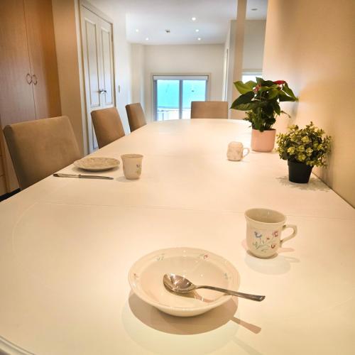 a table with a plate and a spoon and a cup at The Regent Guesthouse in Sydney