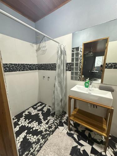 a bathroom with a sink and a mirror at Studio Apartment 2 & AC-2 Pools-Jungle-Beach-WiFi-TV in Cocles