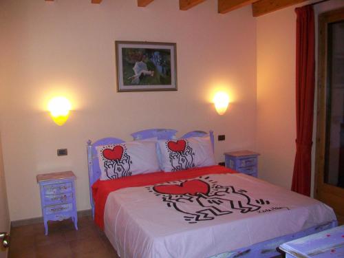 a bedroom with a bed and two night stands at Agriturismo Radaméz in Monzambano