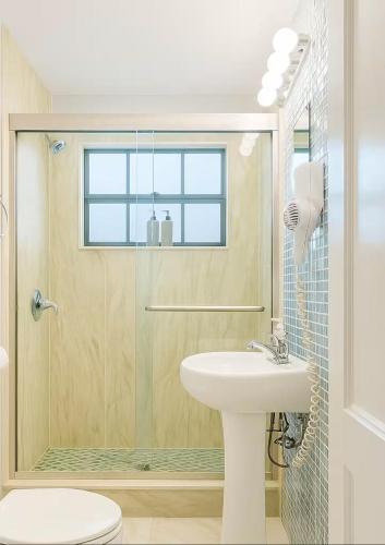 a bathroom with a shower and a sink and a toilet at Charming 1BR Canal Front Retreat in Naples