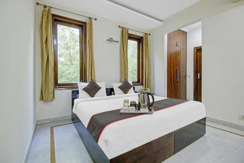 a bedroom with two beds and two windows at Collection O Imperial Oak Near Leisure Valley Park in Gurgaon