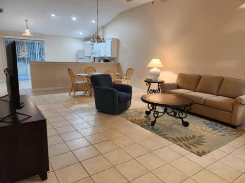 a living room with a couch and a table at Spacious 3BR 2BA Furnished Home in Palm Coast Perfect for Mid-Term Stay in Palm Coast