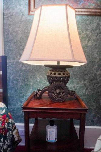 a table with a lamp on top of it at Main Oak Manor in Gallipolis