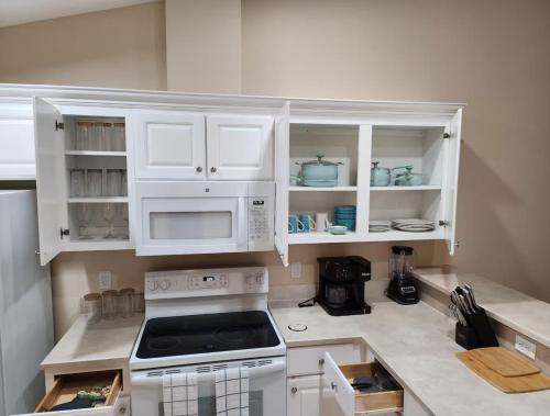 a kitchen with white cabinets and a stove at Spacious 3BR 2BA Furnished Home in Palm Coast Perfect for Mid-Term Stay in Palm Coast