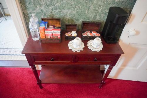 a wooden table with a television and a table with food at Main Oak Manor in Gallipolis