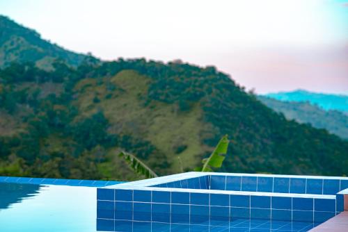 a swimming pool with a mountain in the background at Quinta Maka VistaHermosa in Villeta