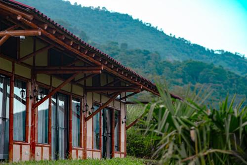 a building with a mountain in the background at Quinta Maka VistaHermosa in Villeta