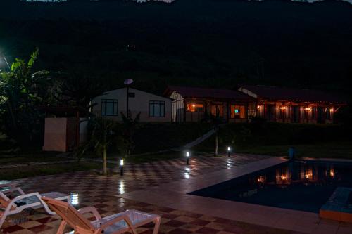 a night view of a house with a swimming pool at Quinta Maka VistaHermosa in Villeta