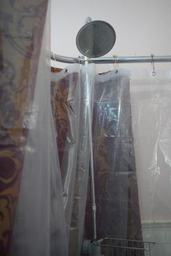a shower curtain is wrapped in plastic in a bathroom at Main Oak Manor in Gallipolis
