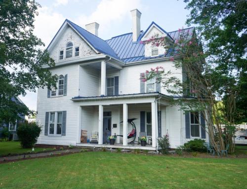 a white house with a blue roof at Main Oak Manor in Gallipolis