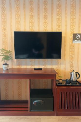 a living room with a flat screen tv on a table at Sapa Elegance Hotel in Sa Pa