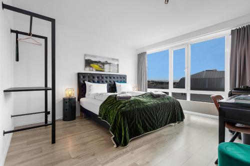 a bedroom with a bed and a large window at City Center Hotel in Reykjavík