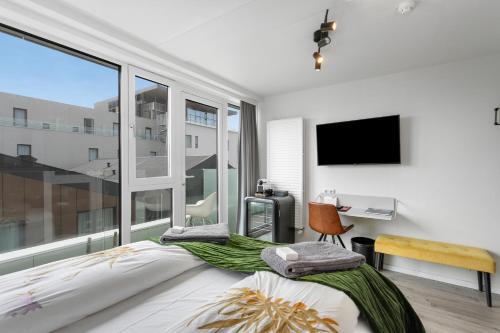 a bedroom with a bed and a large window at City Center Hotel in Reykjavík
